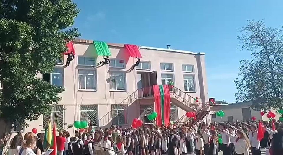 Один из самых эффектных моментов торжественной линейки 15-й школы - спуск скалолазов с крыши здания школы с лентами цвета флага ПМР